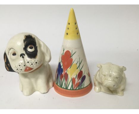 A Staffordshire Clarice Cliff style conical sugar shaker and two ceramic dogs including a Royal Doulton example.