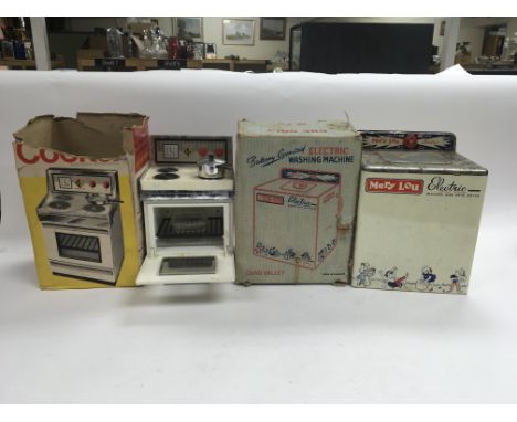 A boxed toy washing machine, a boxed cooker, a boxed pocket stylophone and a toy accordion.