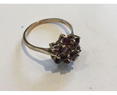 A 9ct Gold Ladies ring set with a cluster of amethyst stones.