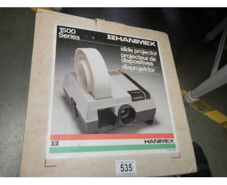 A boxed vintage Hanimex projector with slides.