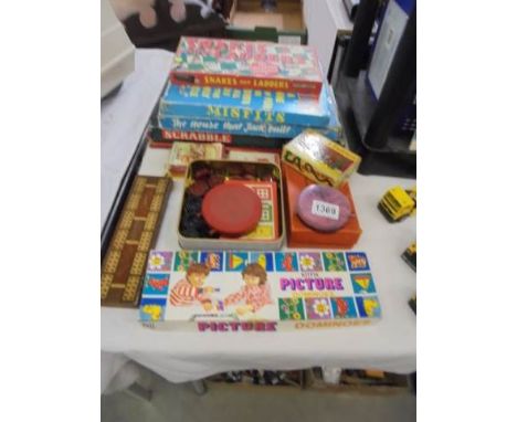 A quantity of vintage board games, playing cards and an inlaid cribbage board.