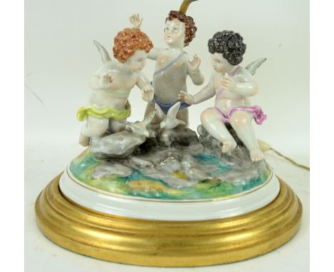 Dresden porcelain figural group of three cherubs with doves, on oval base, converted to a lamp, 16 cm .          Please see e