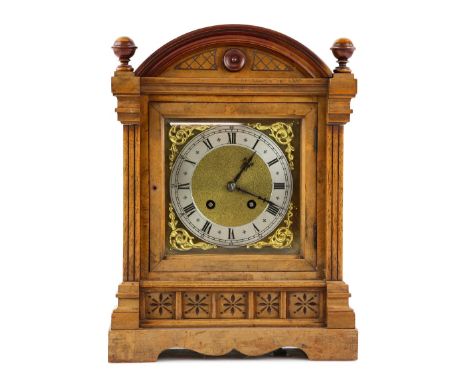 Early 20th century walnut cased eight day mantle clock with brass spandrells..          Please see ewbanks.co.uk for conditio