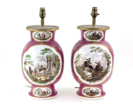 Pair of German porcelain lamp bases, the puce ground with panels of waring figures, Augustus Rex mark to bases, 36cm high,.  