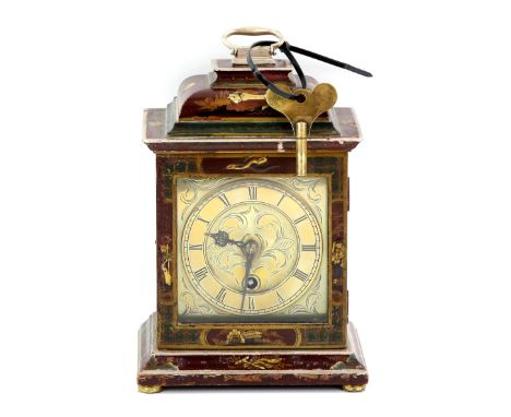 Early 20th century mantel clock with red lacquered case, brass dial with single train movement, 29cm high.     We do not guar