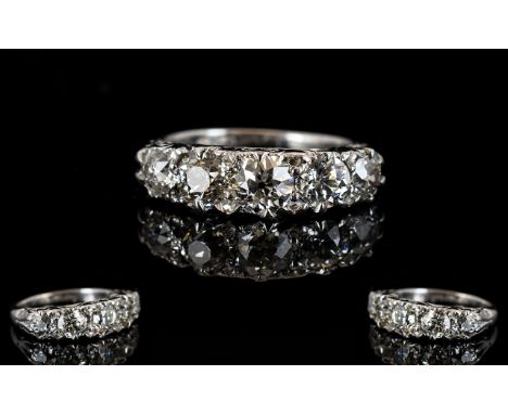 Antique 18ct White Gold Diamond Ring Set with five graduating diamonds between diamond spacers, the largest approx 0.45cts, E