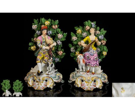 A Pair Of Late 19th Century Chelsea Style Bocage Musician Figures Each in polychrome enamel, decorated and modelled standing 