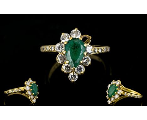 18ct Gold Emerald And Diamond Cluster Ring Pear shaped emerald surrounded by 10 round brilliant cut diamonds - one missing. D