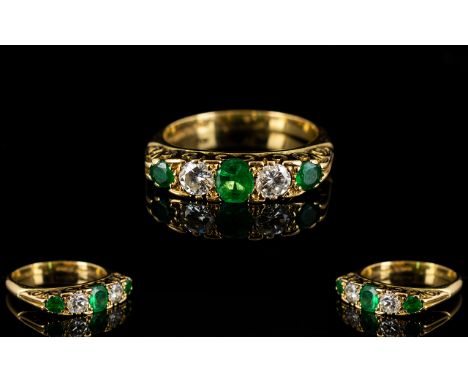 18ct Emerald And Diamond Ring Alternating emerald and diamonds in a scroll mount, fully hallmarked, ring size L 1/2