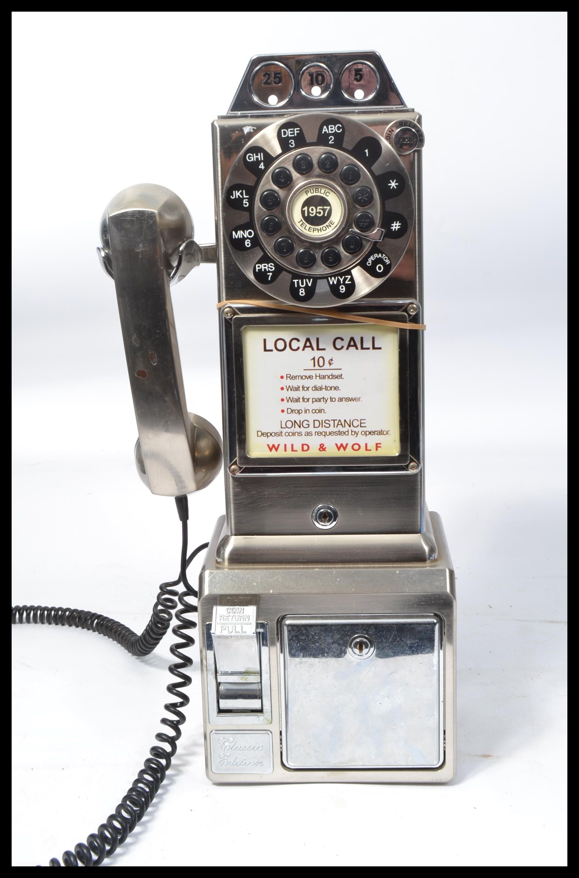 An American style contemporary coin operated wall telephone by Wild and