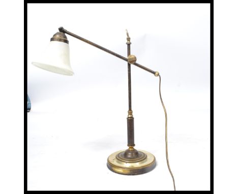 A vintage retro 20th century industrial brass anglepoise type lamp raised on a stepped circular base with adjustable neck and