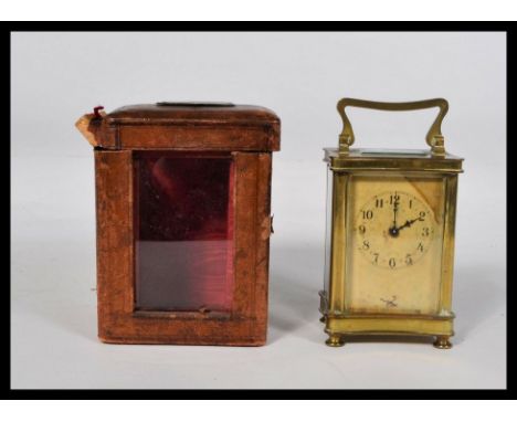 An early 20th century French gilt brass cased carriage clock having faceted hand and Arabic numeral chapter ring. Complete wi