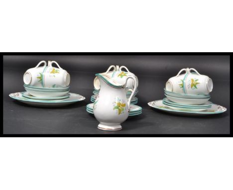 A 19th century tea service hand painted with leaves and foliage having blue bands. Consisting of cups, saucers ,side plates, 