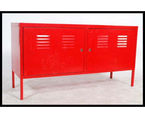 A vintage retro style metal tool cabinet / sideboard, two swing doors raised on square legs finished in a vivid red.&nbsp; Me