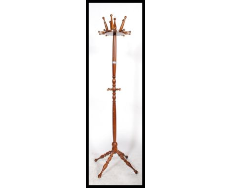 A vintage 20th century antique style hat coat stand of unusual form with bobbin turned legs supports and arms. Please see ima