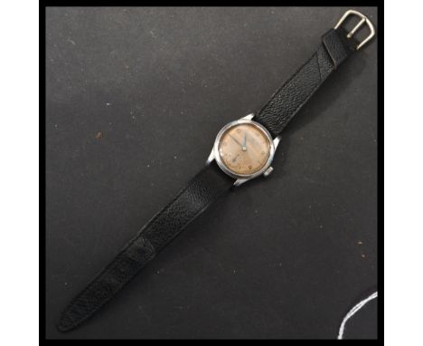 A vintage 20th century Omega 1940's stainless steel cased wrist watch. The champagne dial having Arabic and baton numerals wi