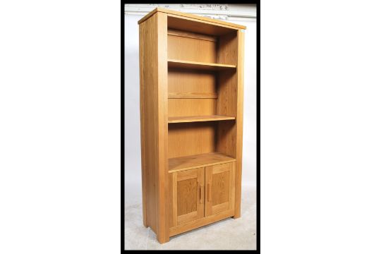 A Contemporary Chunky Oak Upright Bookcase Cabinet With Cupboard