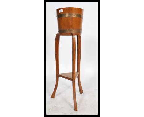 A 19th century coopered oak and brass bound barrel planter - plant stand torchere by Lister of Dursley. Raised on squared sup