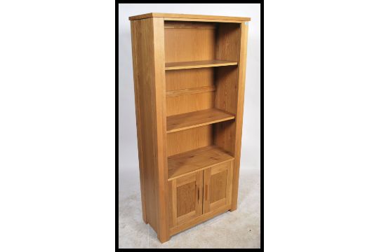 A Contemporary Chunky Oak Upright Bookcase Cabinet With Cupboard