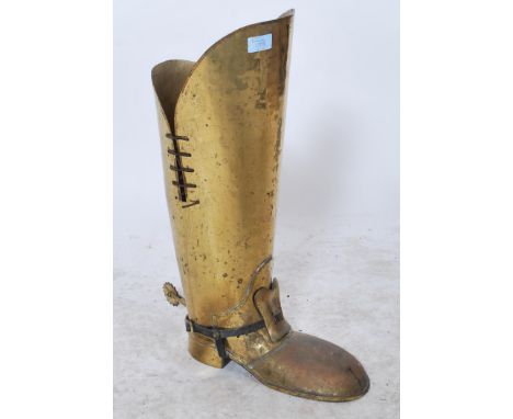 A large vintage 20th century novelty brass stick stand in the form of a large brass cavalier`s boot with spurs. Measures 57 c