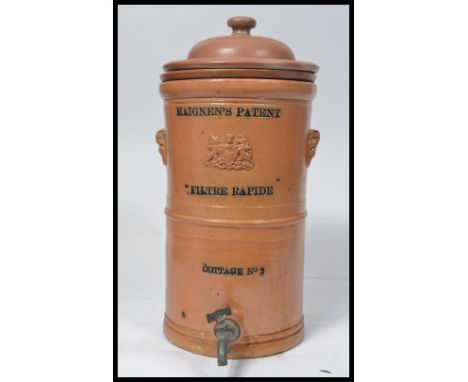 A vintage early 20th century cylindrical Maignen's Filtre Rapide salt glazed wine / water filter, with applied Royal Crest to