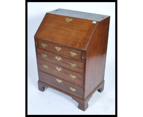 A 19th century Georgian mahogany bureau being raised on bracket feet with a bank of drawers having fall front writing bureau 