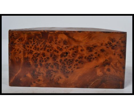A good quality Amboyna wood tea caddy / cigar box of 20th century origin, rectangular form with hinged top and polished inter