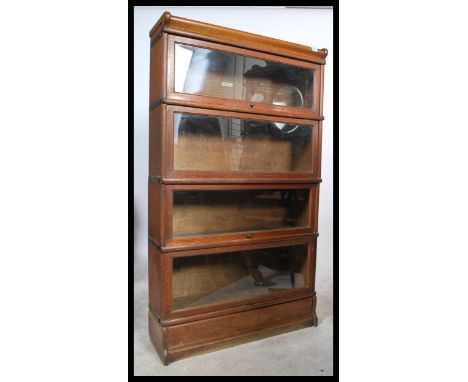 An Edwardian oak&nbsp; 4 section /&nbsp; tier lawyers - barristers stacking bookcase cabinet by&nbsp; Globe Wernicke. The cab