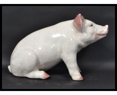 A vintage 20th century advertising point of sale Butchers shop window large ceramic model of a pig. The pig modelled seated w