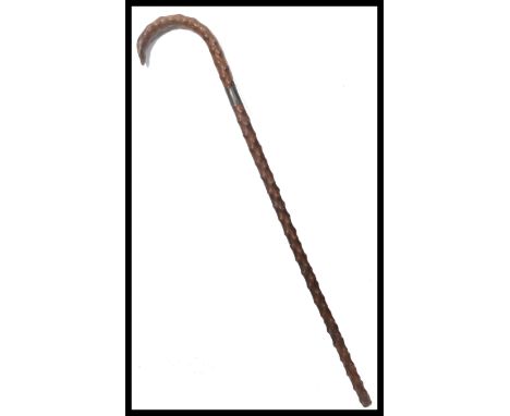 A vintage 19th / early 20th century blackthorn walking stick having a silver hallmarked collar. Measures 87 cm high.