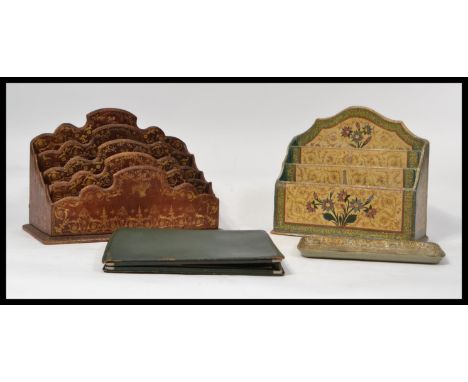 Two vintage 20th century papier mache desk tidies of sectional form the first being covered with a leather tooled coating tog