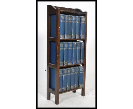 A set 1920's Dickens books housed within a wooden display shelf. Please see images.81x33x16