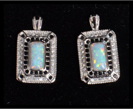 A pair of sterling silver marcasite and opal set earrings of rectangular form&nbsp;complete in jewellery presentation box.