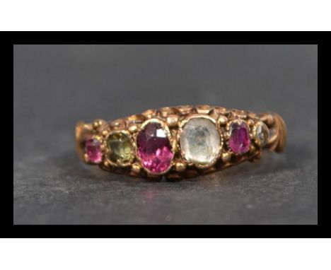 A Victorian hallmarked 15ct gold ring having multi coloured gemstones including ruby and rose cut diamond in leather jeweller