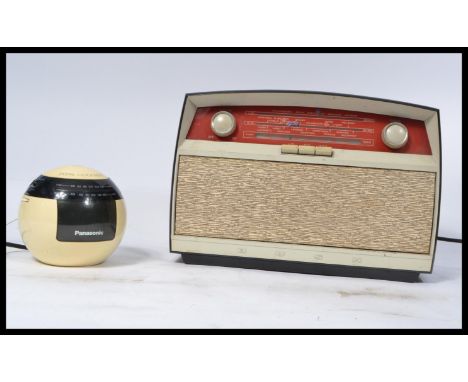 A vintage retro 20th century Bakelite Bush radio having a grille front with red tuning panel along with a Panasonic ball radi