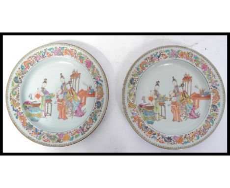 A pair of 19th century Chinese plates having hand painted poly-chrome enamel borders with the central cartouche's depicting s