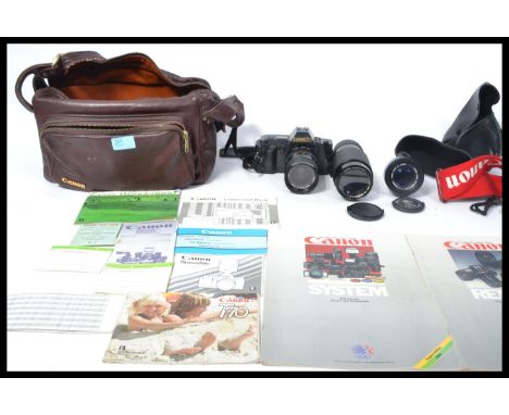 A vintage 20th Century Canon T70 35mm camera and lenses to include FD 50mm, FD 70 - 210mm, FD 35 - 70mm together with insrtuc
