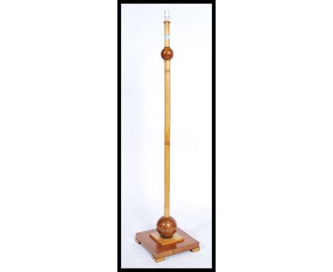 An early 20th Century Art Deco floor standing standard lamp, constructed from burr walnut and beech having a square base with