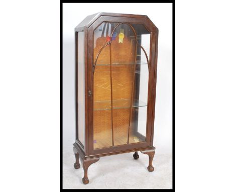 A vintage early 20th century oak cased single glazed door display cabinet raised on cabriole legs on ball and claw feet. 125x