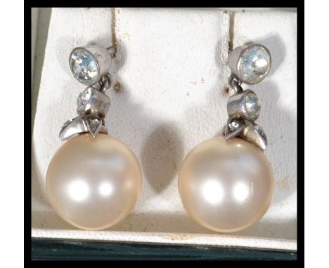 A good pair of vintage pearl and silver marcasite drop earrings having a large pearl with marcasite mount and graduating rhin