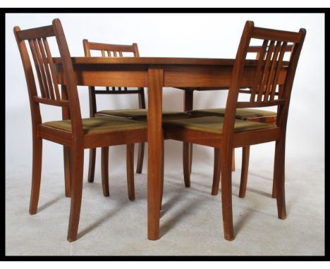 A retro 20th Century teak wood dining suite comprising of an extendable table together with four ladder back dining chairs.&n