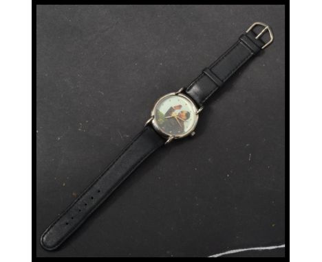 A 20th century Chairman Mao wrist watch having a printed portrait dial with gilt dot numerals and waving hand. Set to a black