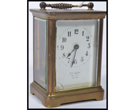 An early 20th century brass carriage clock with enamel dial, roman numeral chapter ring with faceted hands being marked for R
