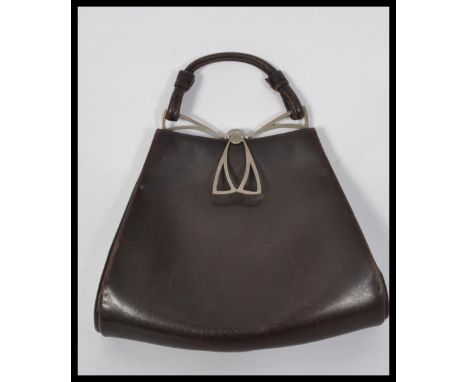 A vintage early 20th century Art Nouveau leather handbag having a white metal clasp. London makers label to interior. Base Me