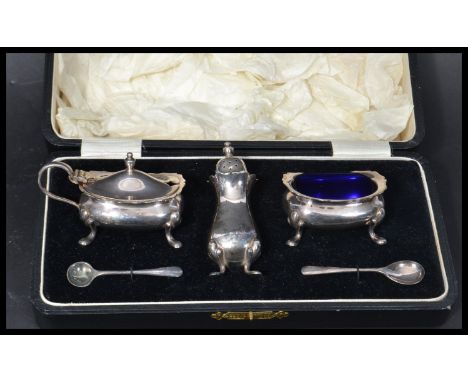 A vintage 20th century Regis plate silver plated condiment salt set in fitted case. Blue glass liners makers stamps to base. 