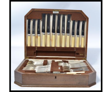 A vintage 20th Century oak cased canteen of cutlery by Walker and Hall, a six person setting consisting of forty seven pieces