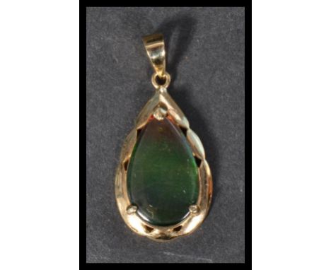 A hallmarked 14ct gold teardrop pendant set with a black opal doublet. Weight 2.9g. 