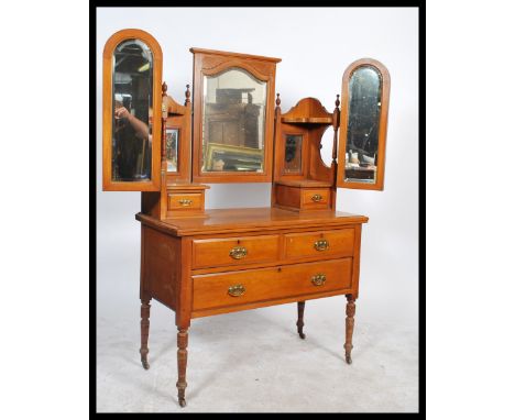 An Edwardian satin walnut dressing table chest of drawers having short over deep drawer configuration raised on turned legs w