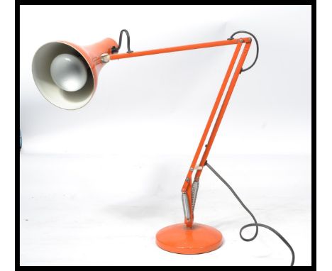A retro 20th century Herbert Terry anglepoise industrial desk lamp with conical shade raised on a circular base having origin