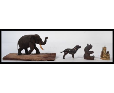 A group of vintage 20th century novelty animals items to include Blackforest carved bear , a cold painted metal dog mastiff a